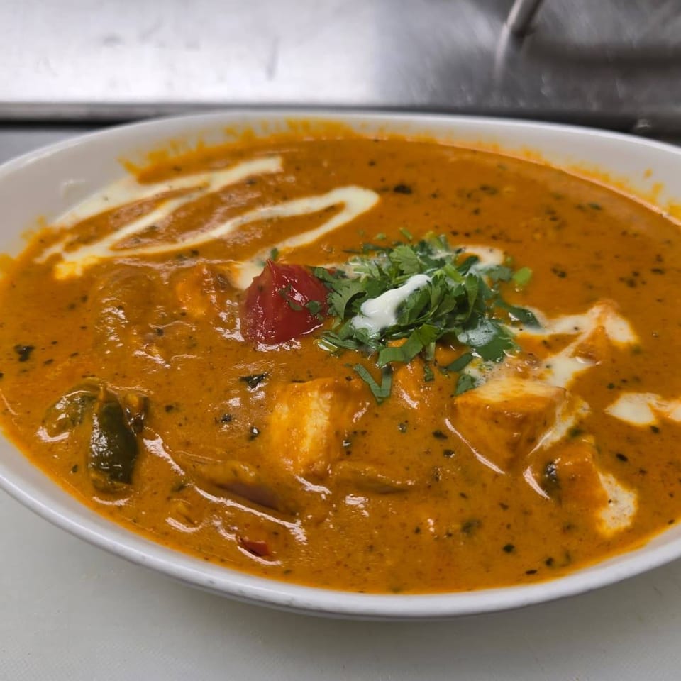 Creamy curry garnished with cilantro.