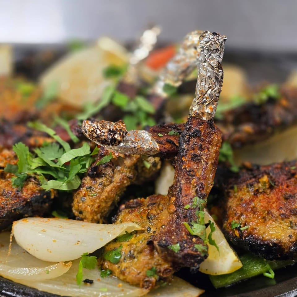 Grilled chops served with onions and lemon.