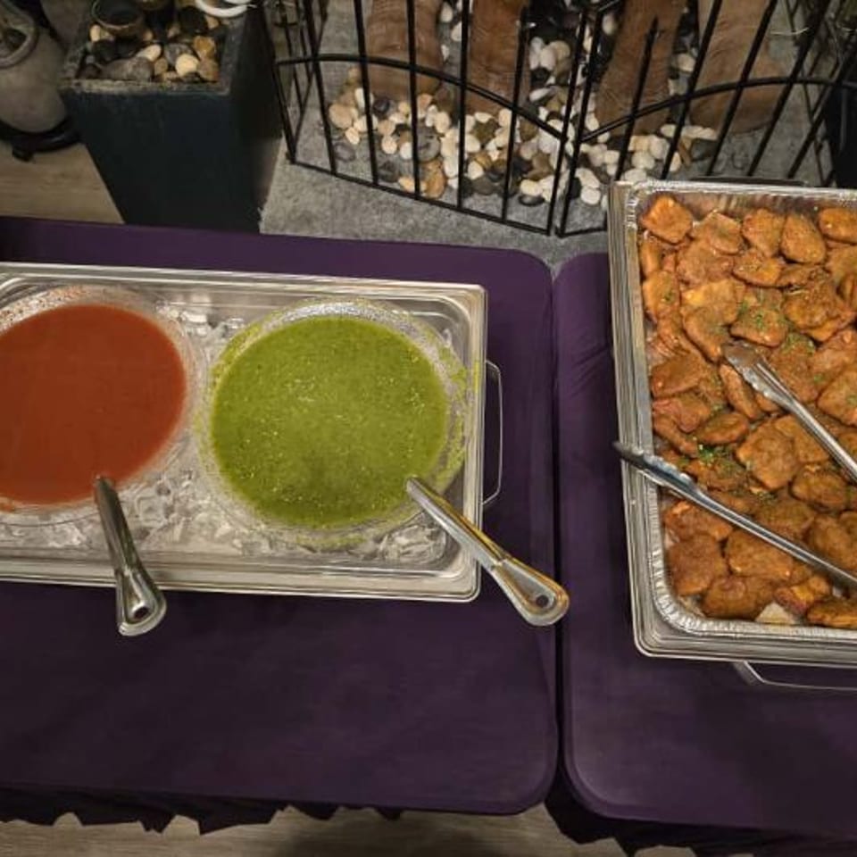 Catering appetizers with red and green chutneys